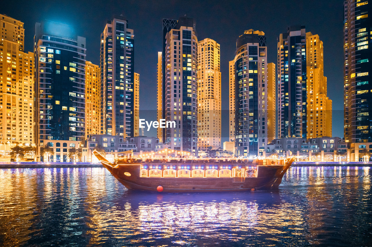 high angle view of illuminated buildings in city at night