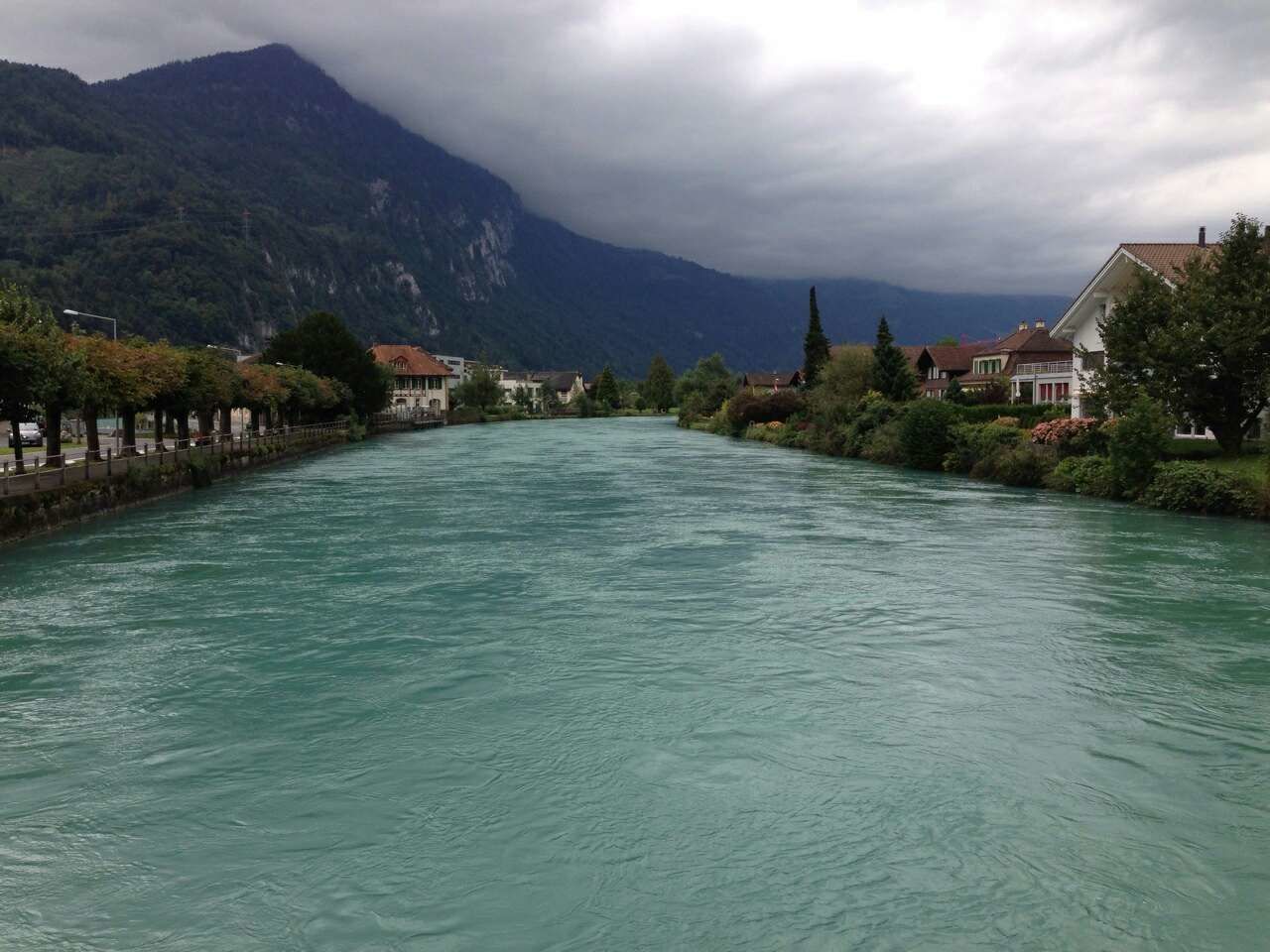 SCENIC VIEW OF RIVER WITH TOWN IN BACKGROUND