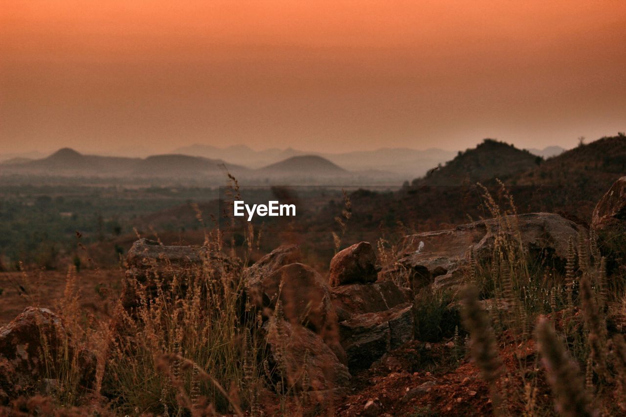 Idyllic view of landscape against sky during sunset