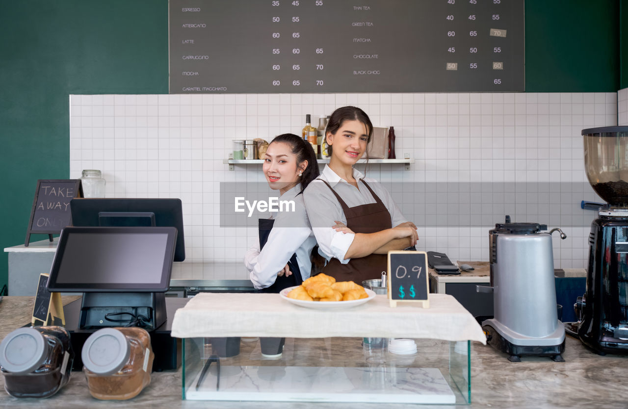 Portrait of chefs standing in kitchen