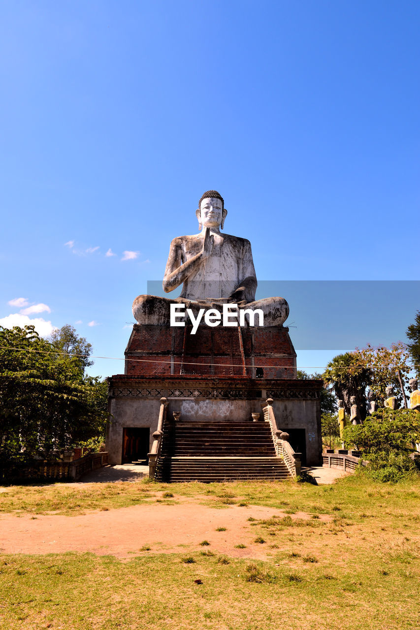 OLD STATUE AGAINST HISTORIC SKY