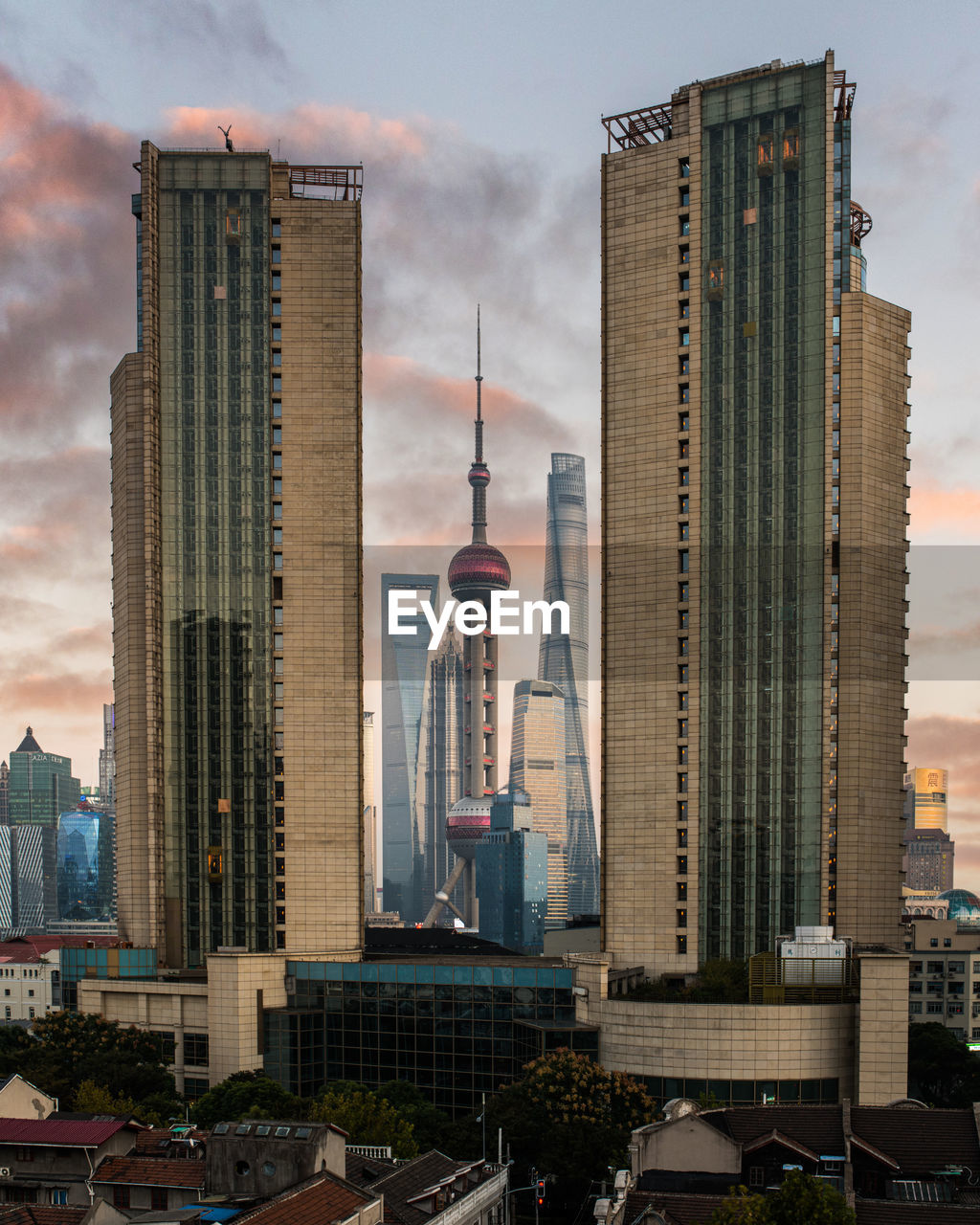 Modern buildings in city against cloudy sky in shanghai