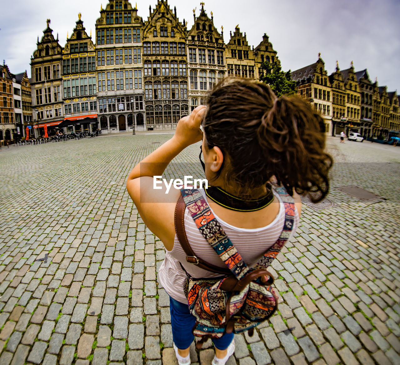 Full length of woman outside historic building against sky in city