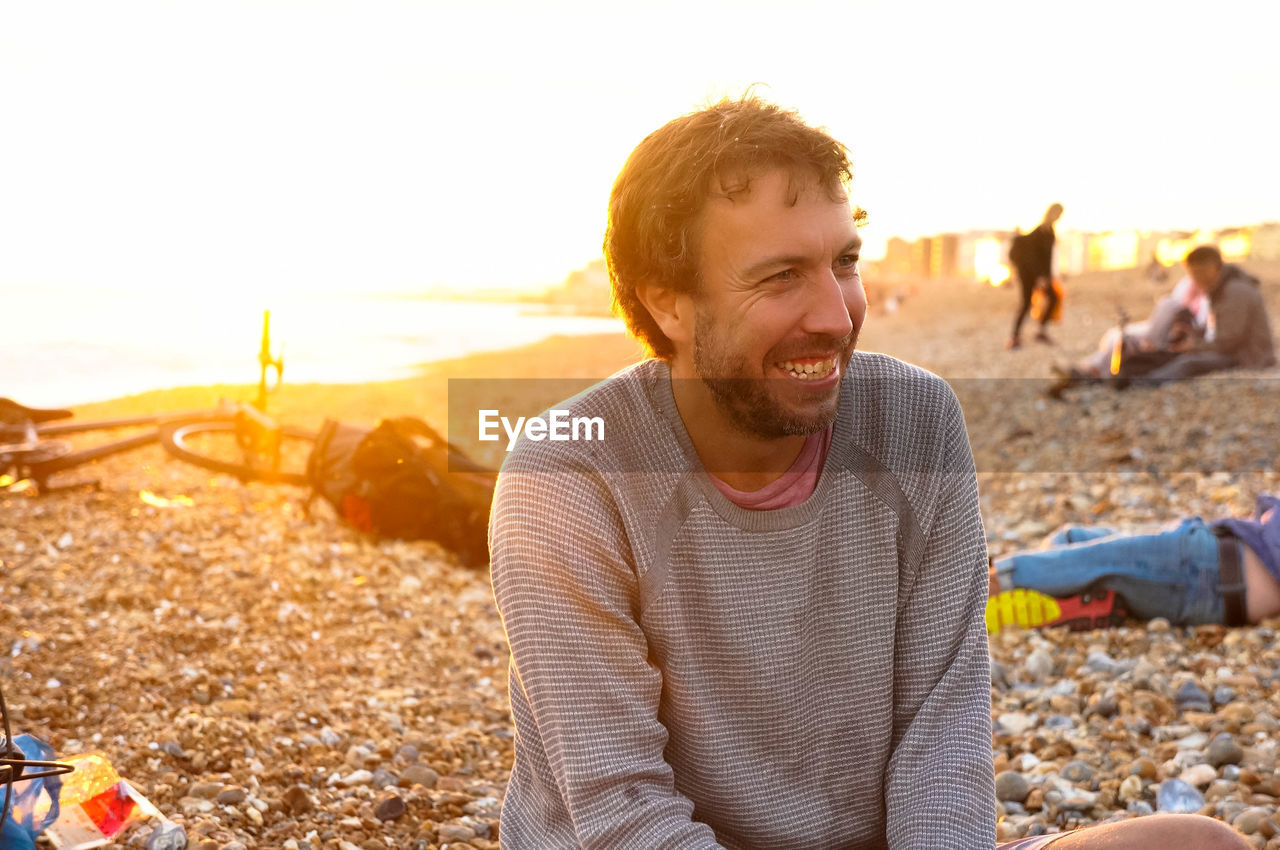 Smiling man sitting at beach