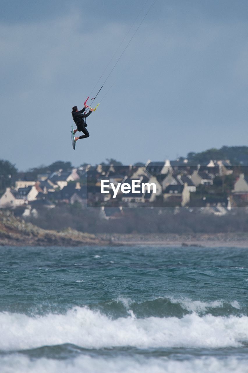 Kitesurfer during high jump above sea 