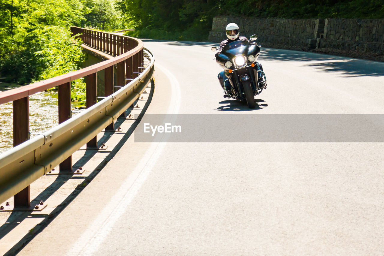 MAN RIDING MOTORCYCLE