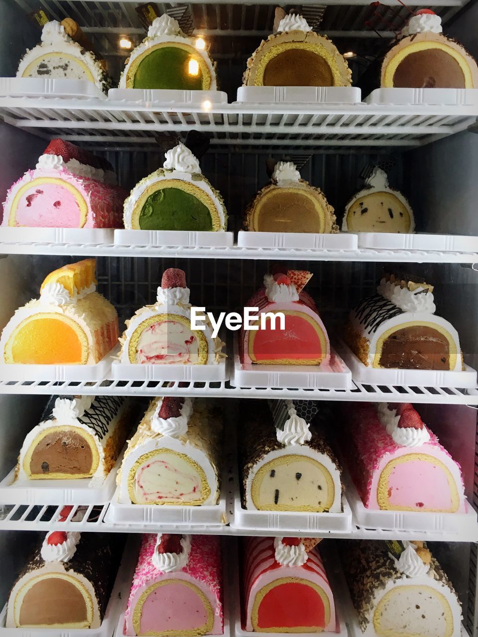 Full frame shot of various cakes in refrigerator at store