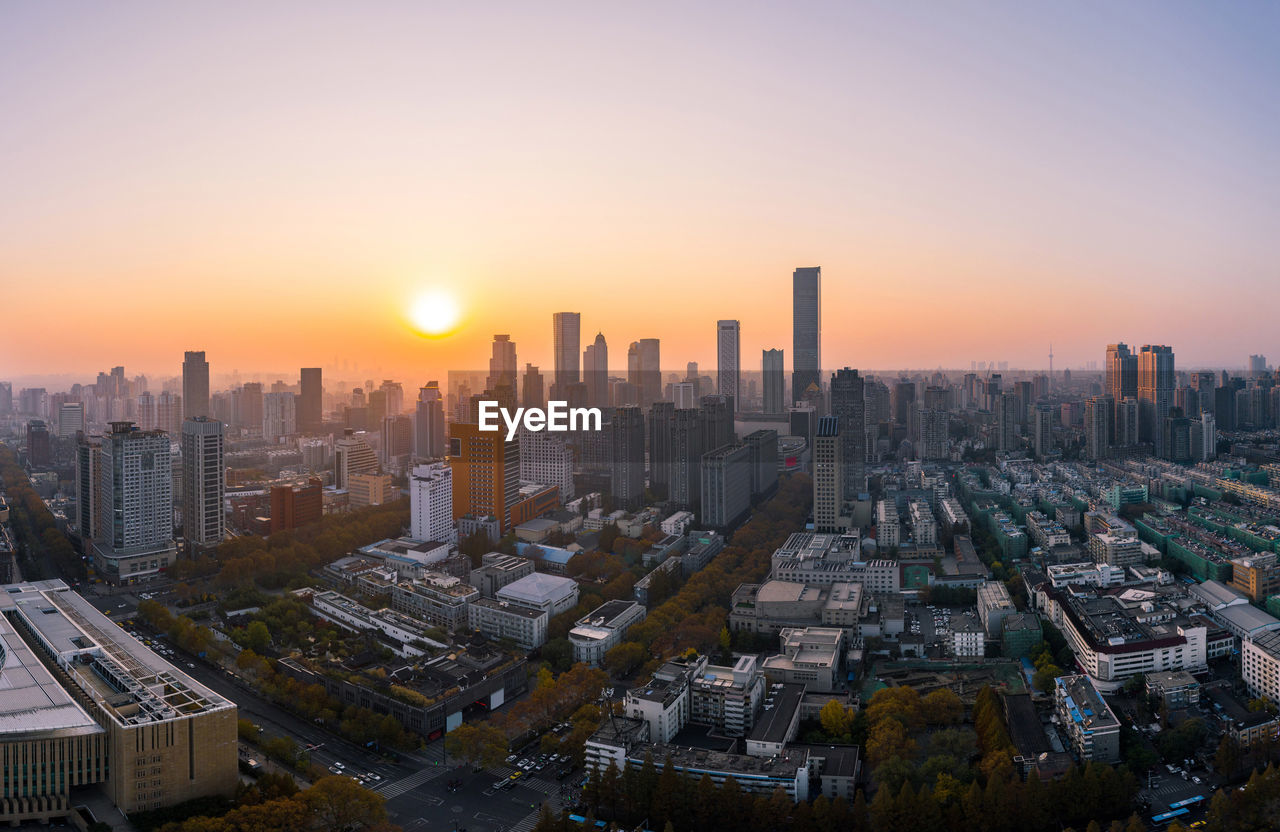 CITYSCAPE AGAINST SKY DURING SUNSET IN CITY