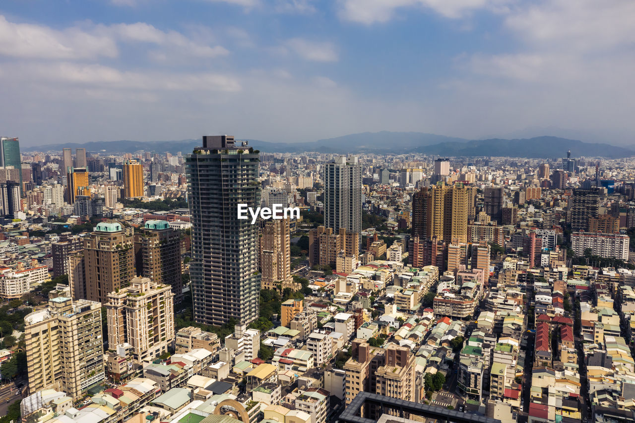 HIGH ANGLE VIEW OF CITY BUILDINGS AGAINST SKY