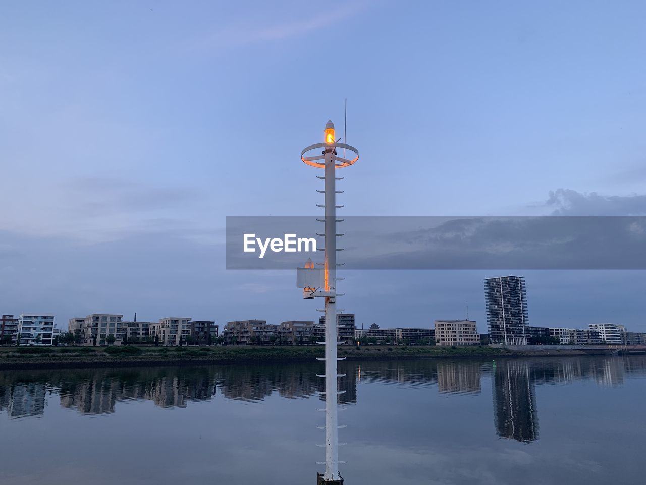 SCENIC VIEW OF LAKE BY BUILDINGS AGAINST SKY