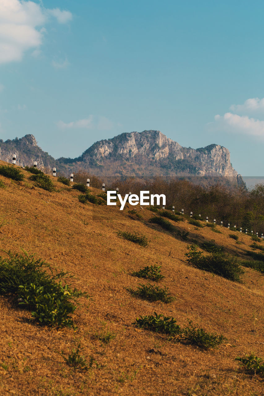 SCENIC VIEW OF LAND AND MOUNTAINS AGAINST SKY