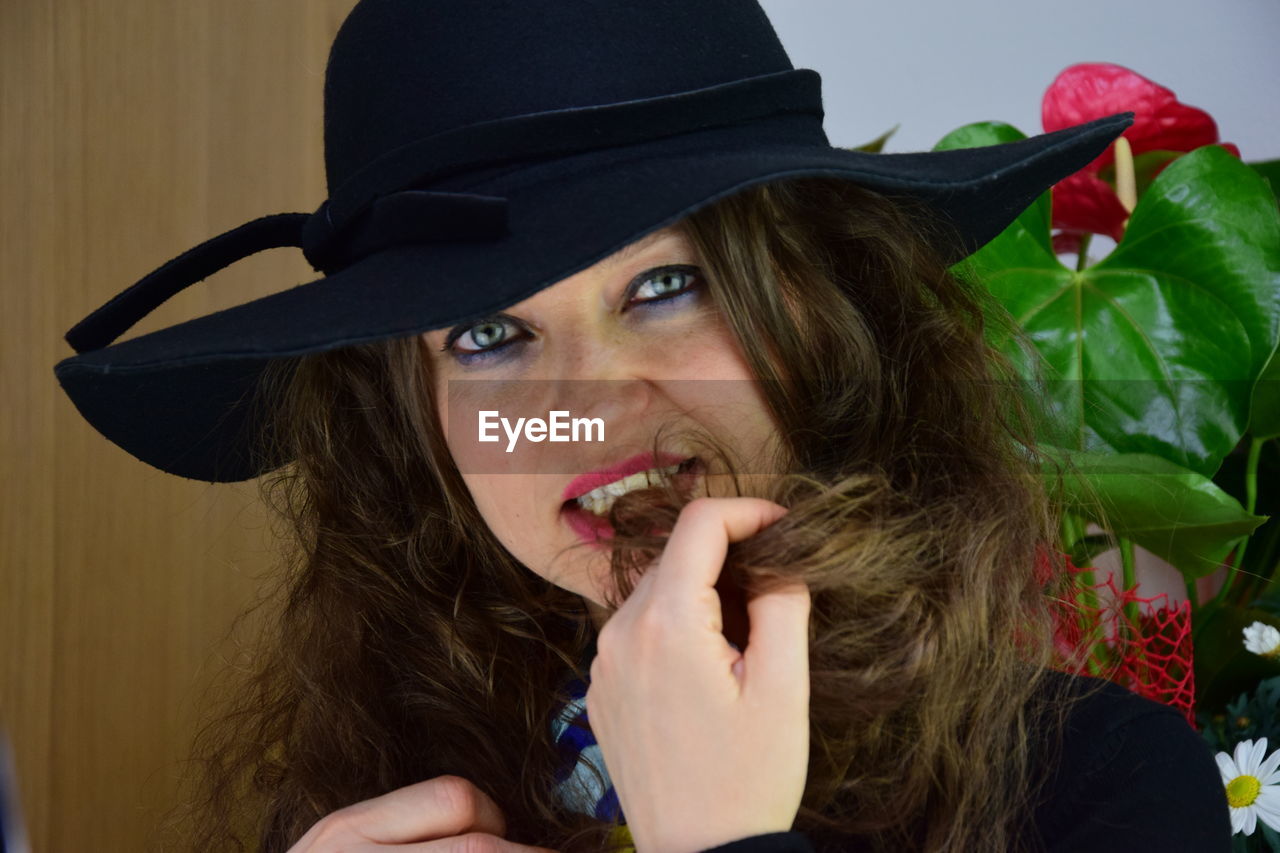 Close-up portrait of woman wearing hat