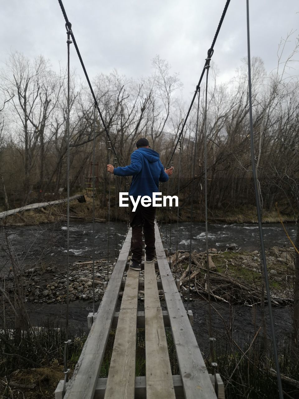 Rear view of man standing on bridge, kamchatka 