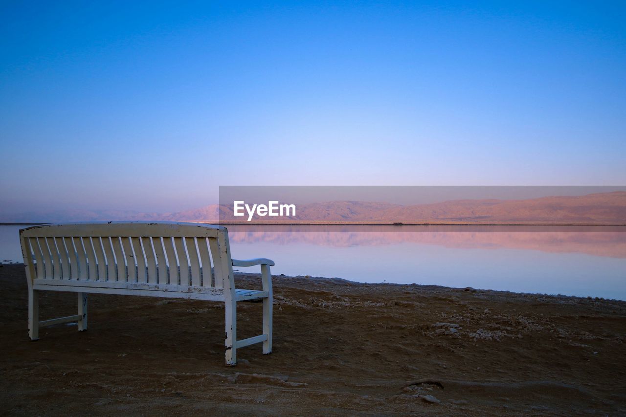 Scenic view of beach against clear blue sky