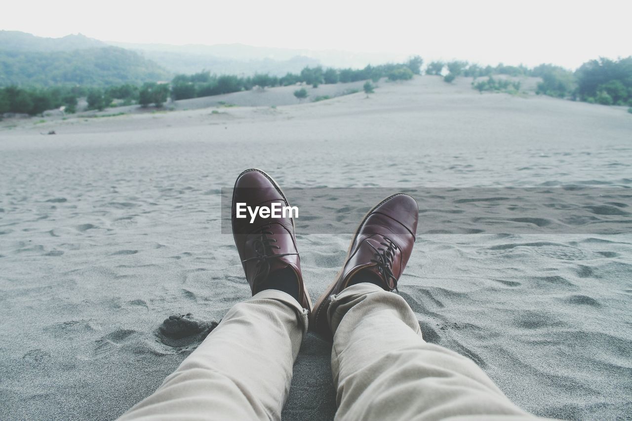 Low section of man on sand