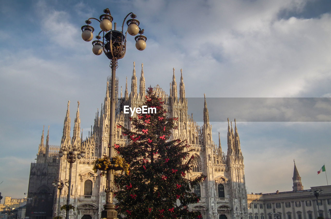 LOW ANGLE VIEW OF CHRISTMAS TREE BY TEMPLE AGAINST SKY