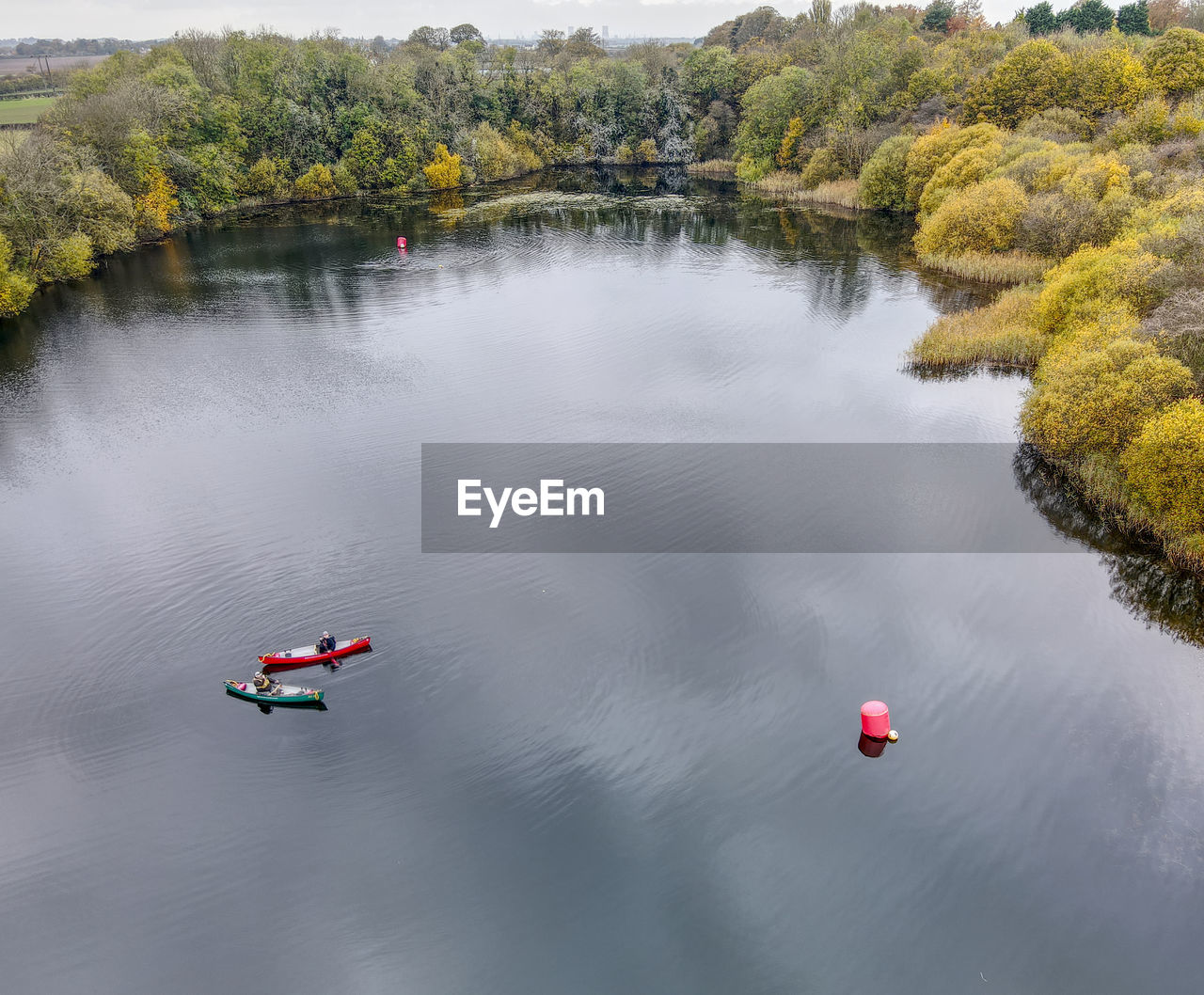 HIGH ANGLE VIEW OF LAKE BY TREES