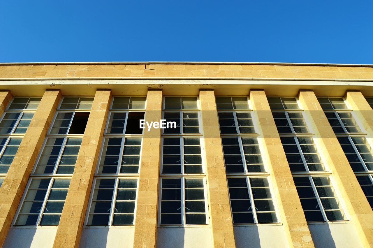 Low angle view of building against clear blue sky