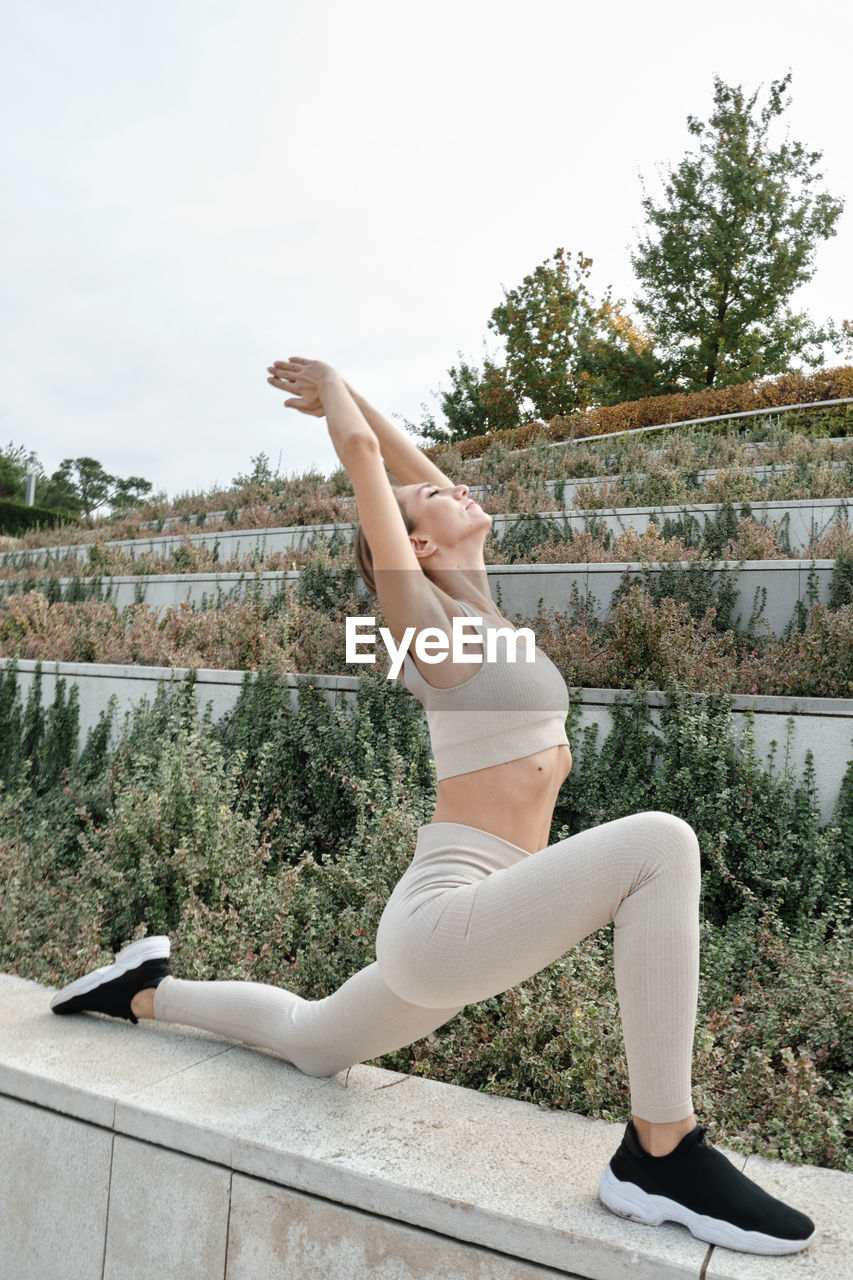 full length of woman exercising on exercise mat