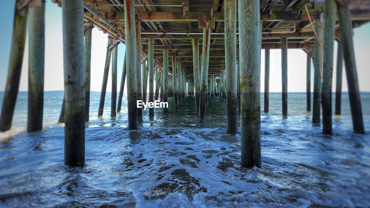 water, architectural column, sea, architecture, built structure, beach, nature, land, day, no people, underneath, outdoors, wood, pier, sky, beauty in nature, horizon, scenics - nature, tranquility, horizon over water