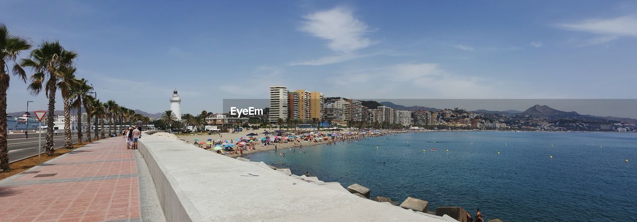 Panoramic view of sea and city against sky