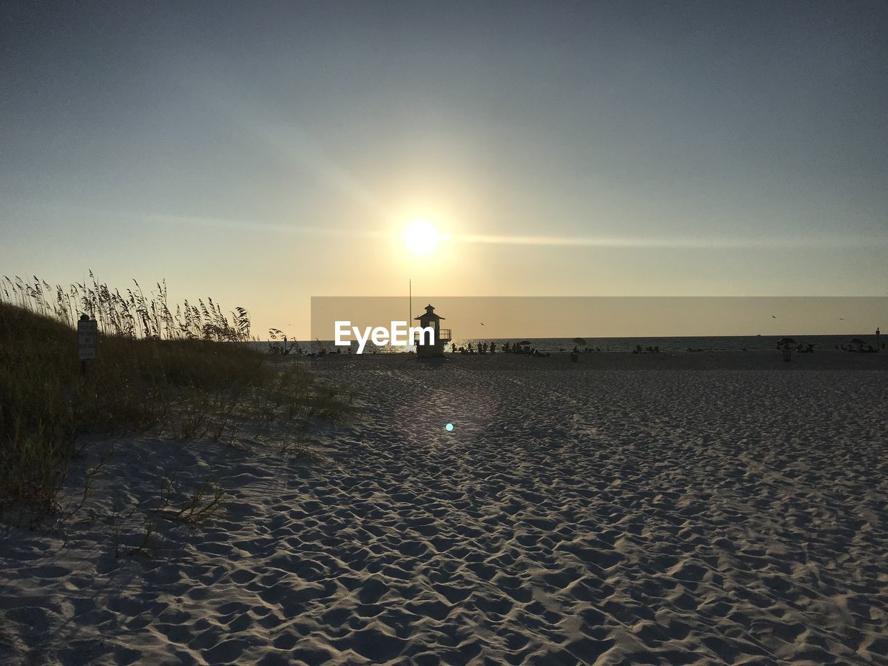 Scenic view of beach against sky during sunset