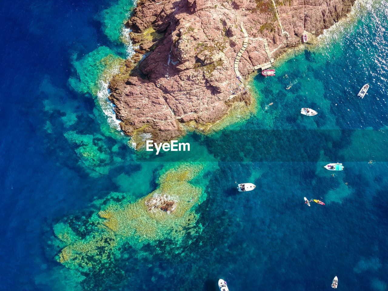 HIGH ANGLE VIEW OF ROCKS AND SEA