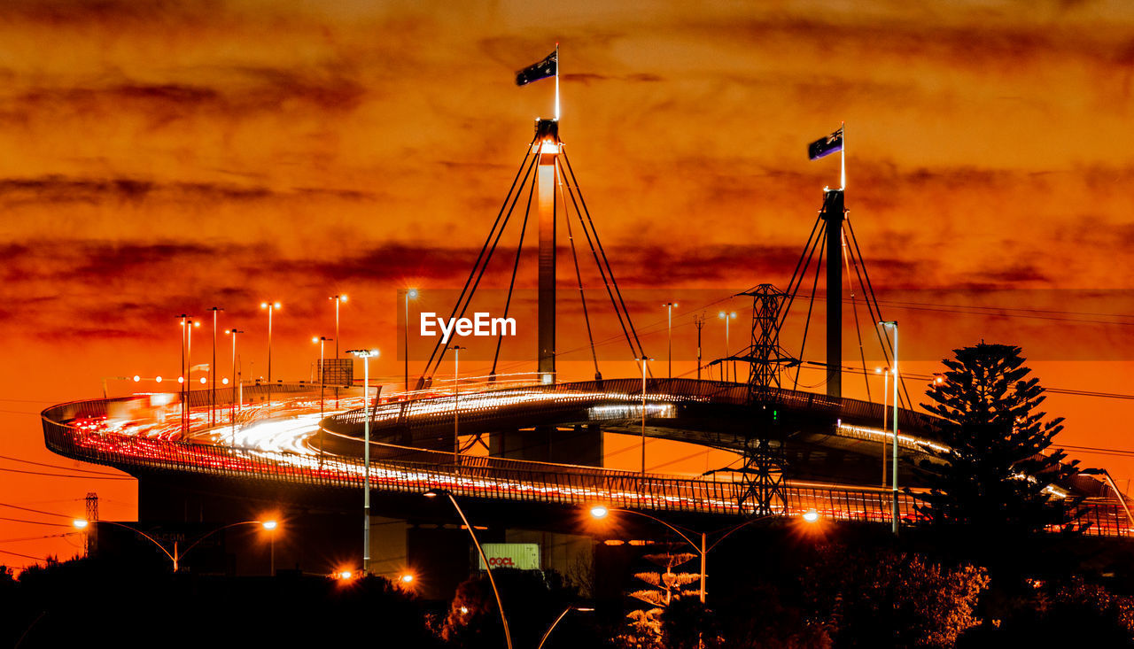 Illuminated bridge against sky in night