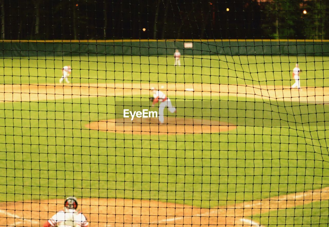 People playing baseball on field