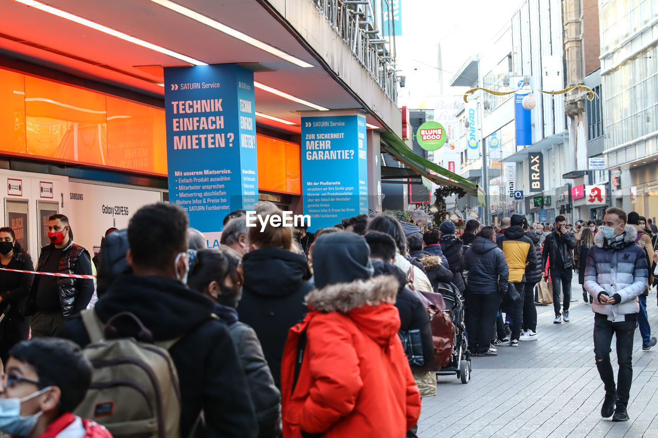 GROUP OF PEOPLE WALKING IN CITY STREET