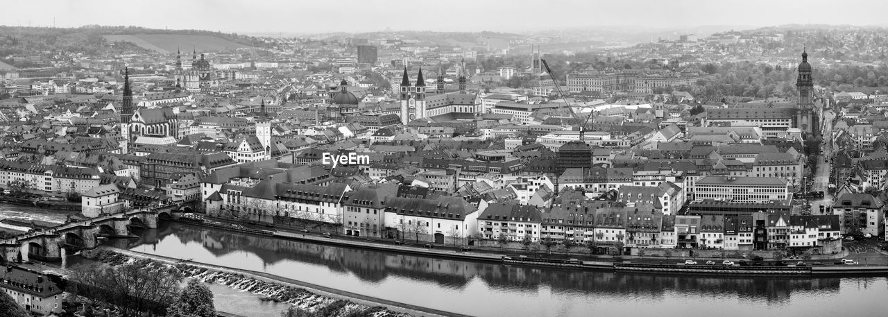 architecture, city, cityscape, built structure, building exterior, black and white, water, monochrome photography, aerial photography, monochrome, building, nature, high angle view, transportation, skyline, sky, travel destinations, river, urban area, no people, residential district, landscape, travel, nautical vessel, outdoors, aerial view, ship, waterway, mode of transportation, day, city life, tourism, bridge, metropolis