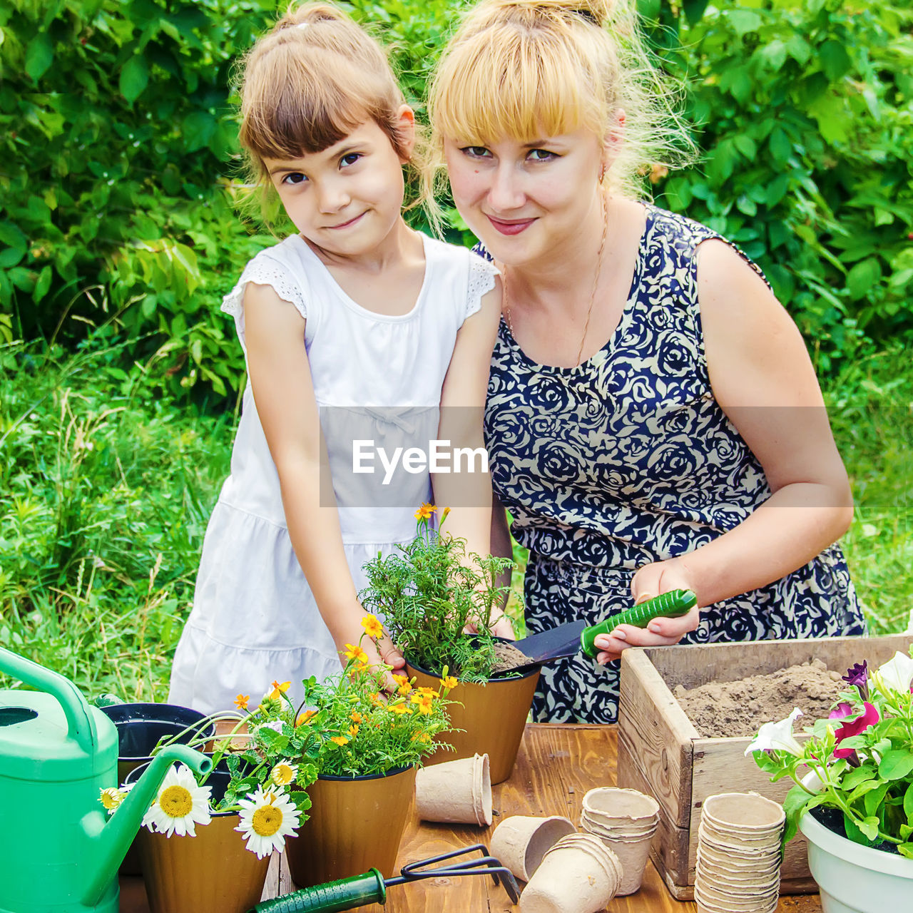 portrait of young woman gardening while planting