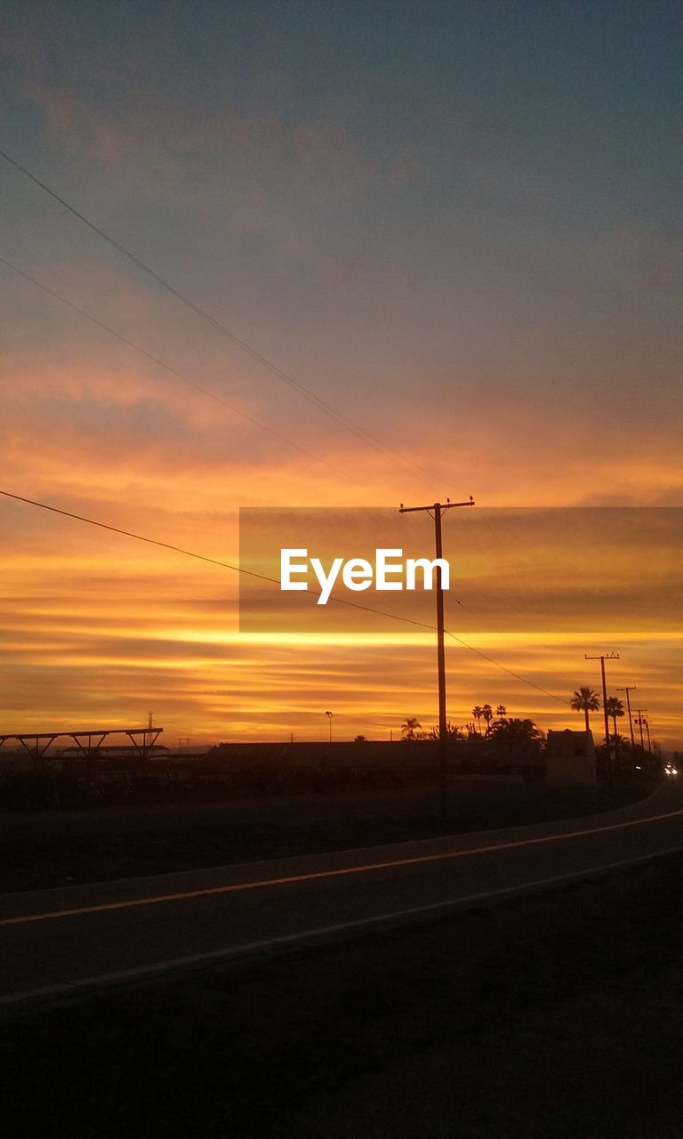 SCENIC VIEW OF ROAD AT SUNSET