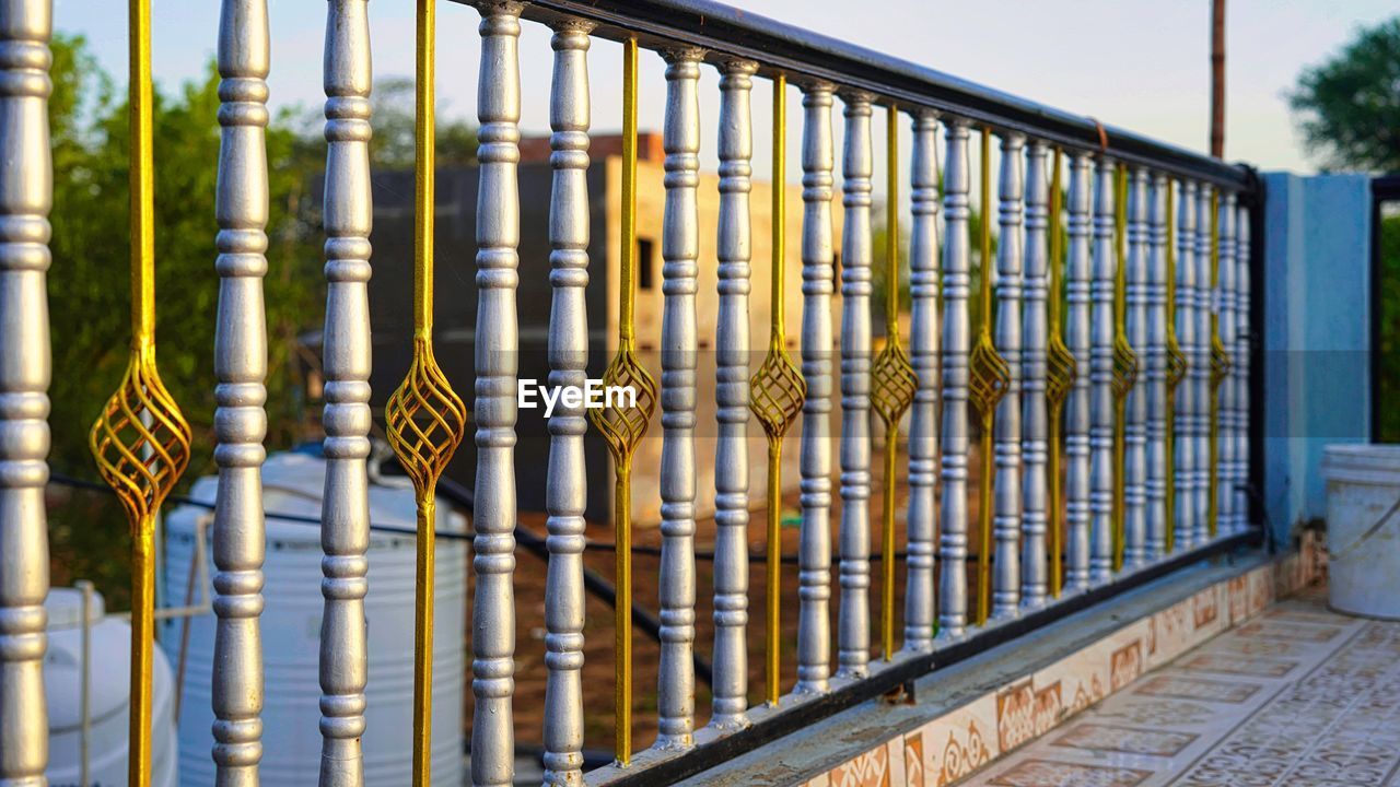 Beautiful decorative cast metal wrought fence with artistic forging. iron guardrail close up. golden