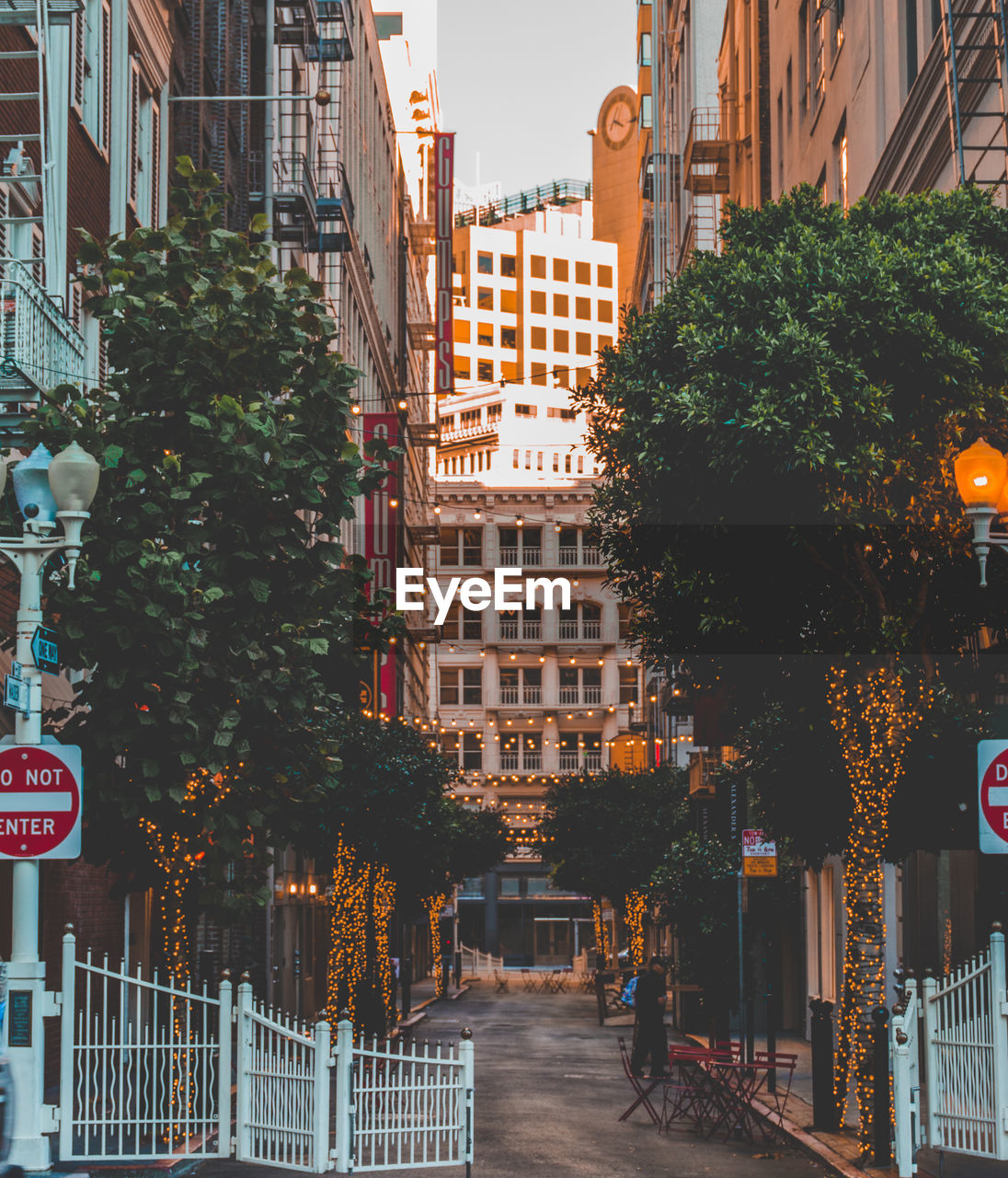 STREET AMIDST BUILDINGS AGAINST CITY