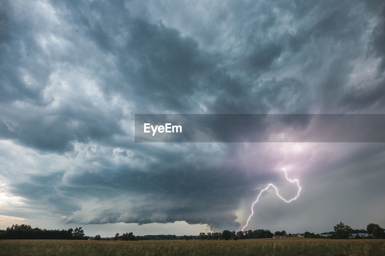 Wall cloud of a supercell storm and lightning.