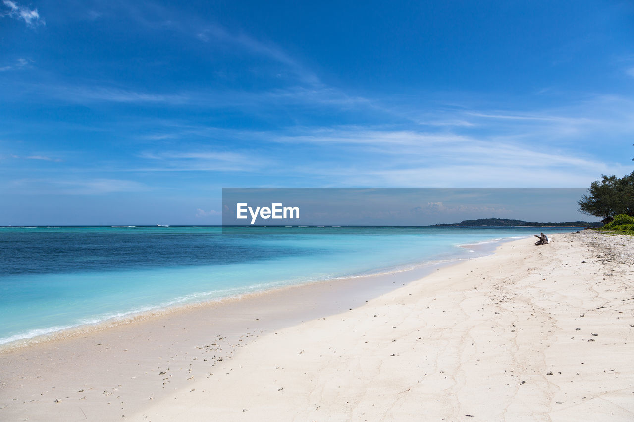 Scenic view of beach against blue sky