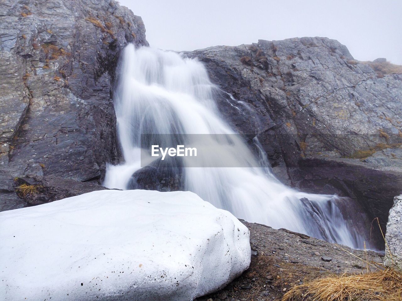 Scenic view of waterfall against sky