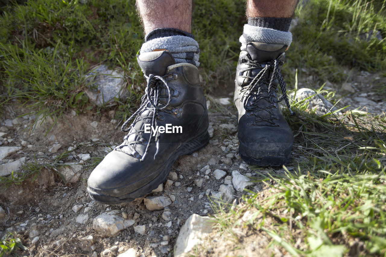 shoe, low section, footwear, human leg, one person, nature, limb, human limb, day, plant, boot, grass, lifestyles, outdoors, land, leisure activity, men, dirt, human foot, adult, standing, sports, hiking