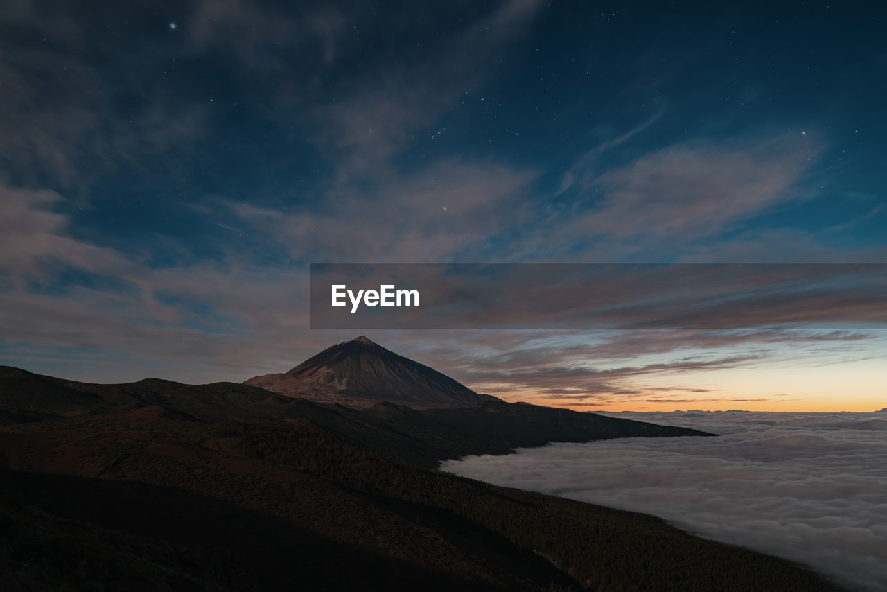 Scenic view of volcano against sky during sunset