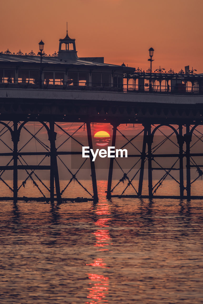 View of pier over sea against sky during sunset