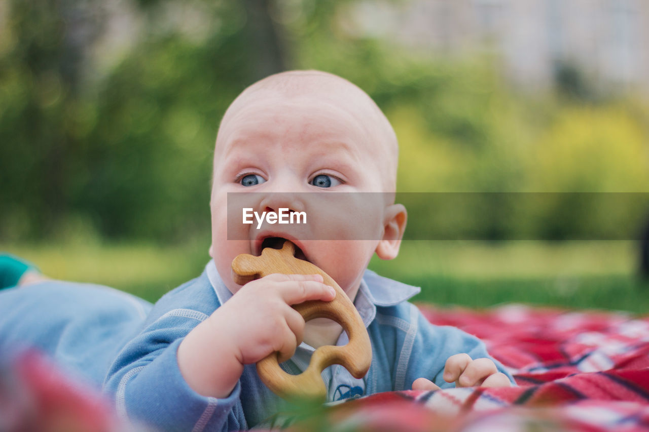 Close-up of cute boy eating toy