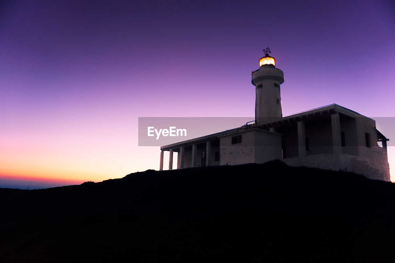 Low angle view of silhouette building against sky during sunset