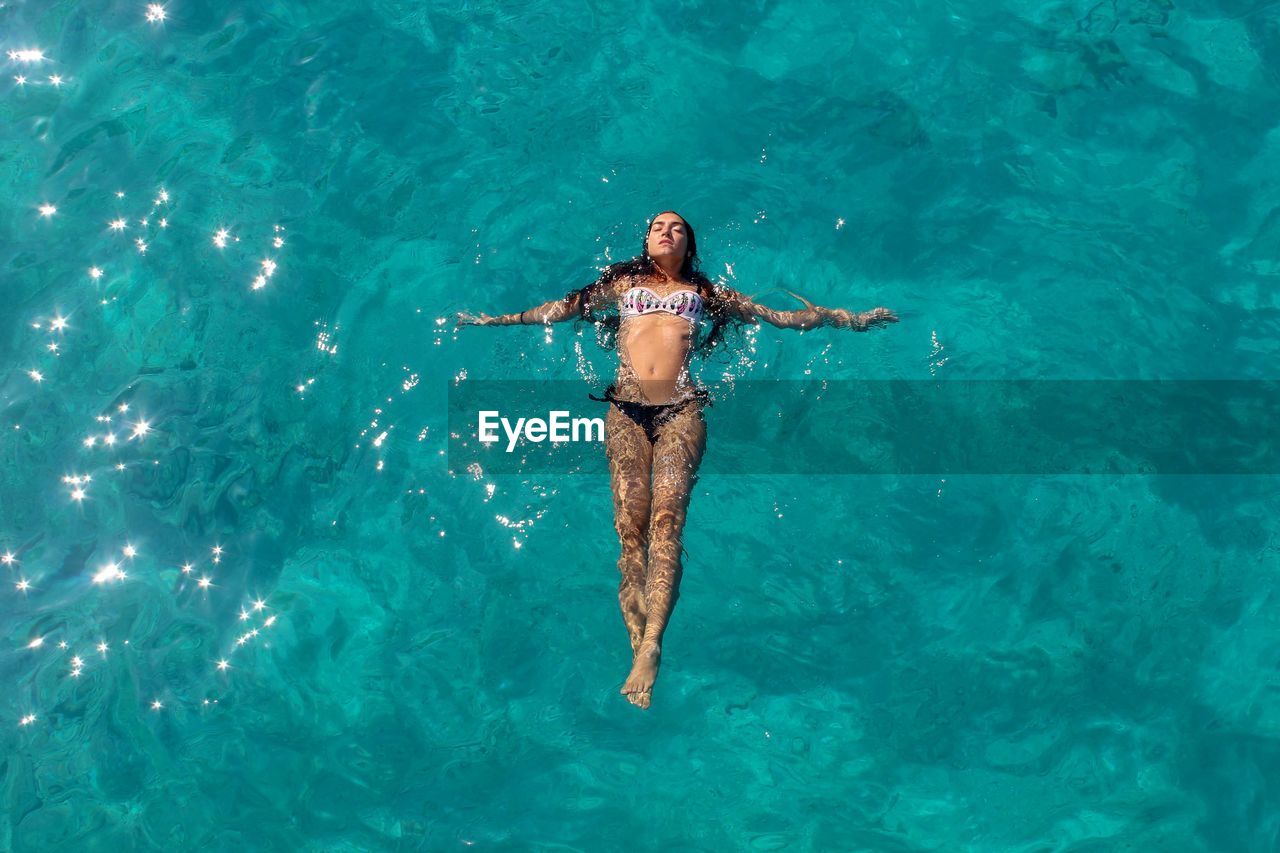 High angle view of woman swimming in sea