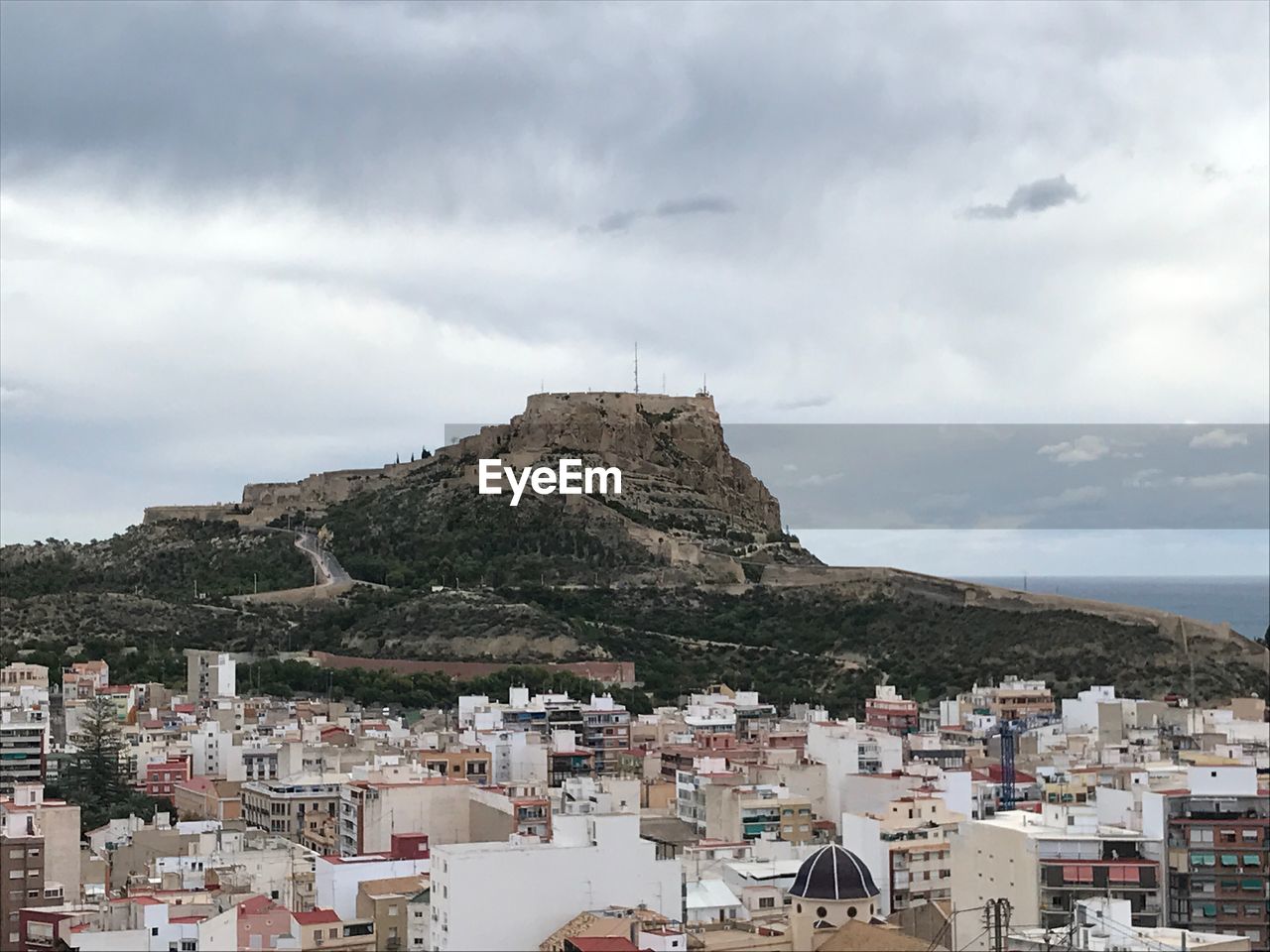 Buildings in town against sky