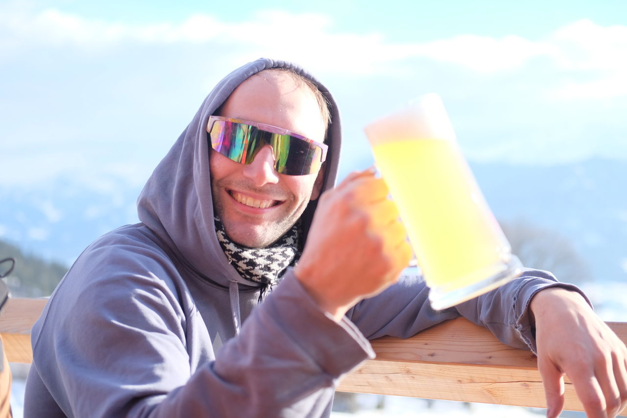 Portrait of smiling man holding drink