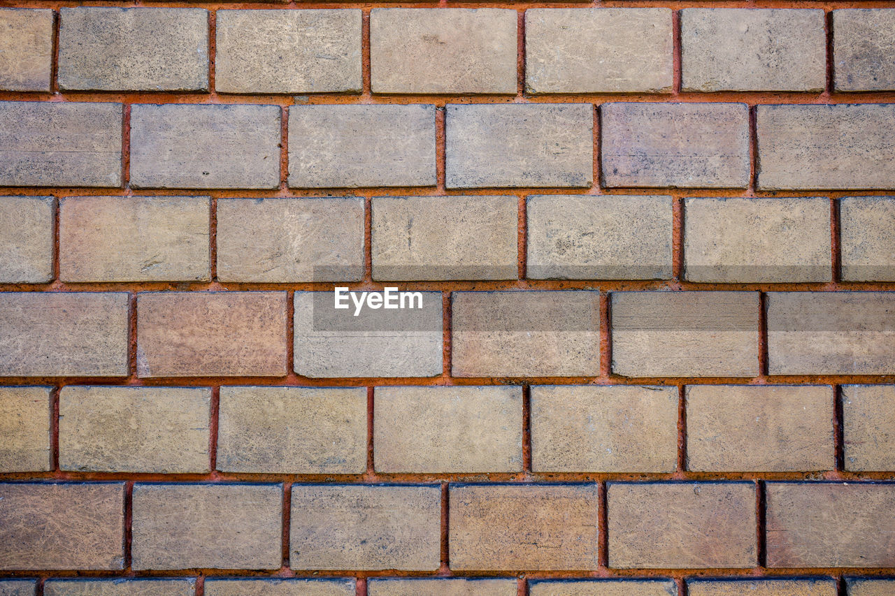 FULL FRAME SHOT OF BRICK WALL WITH TILED FLOOR
