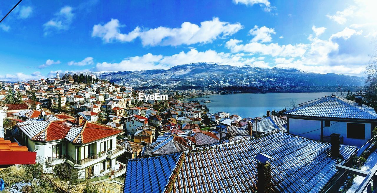 High angle view of houses and mountains against sky