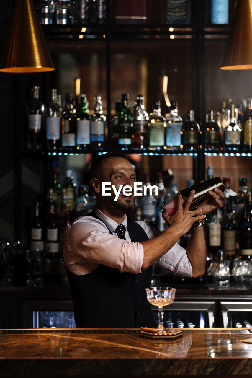 Portrait of man with drink in bar