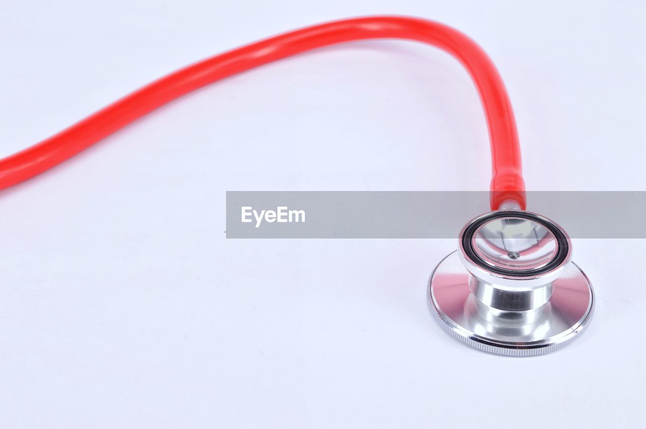 High angle view of stethoscope on white background